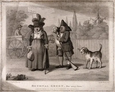 A woman with a wig in one hand and an umbrella in the other stands shouting as a man cleans the barrel of a rifle and a dog stands nearby with a bone in his mouth