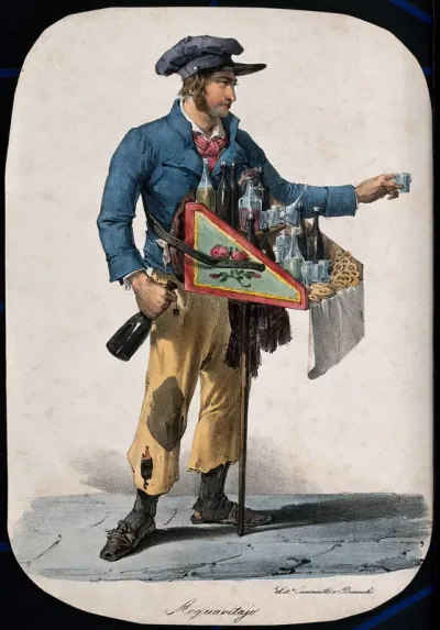 A young man is handing out a glass of brandy from one of the bottles in his tray