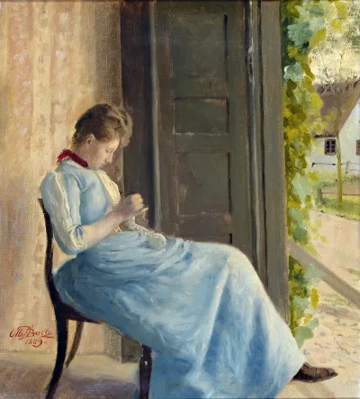 A young woman in a blue dress knitting by an open door.