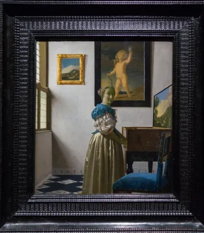 A Young Woman Standing at a Virginal