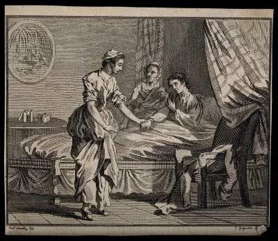 A young woman takes the hand of a sick man, while an older woman listens