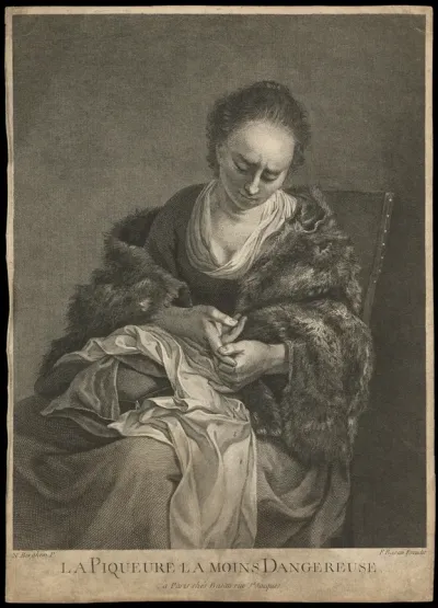 A young woman tending to a cut on her finger from which drops of blood fall