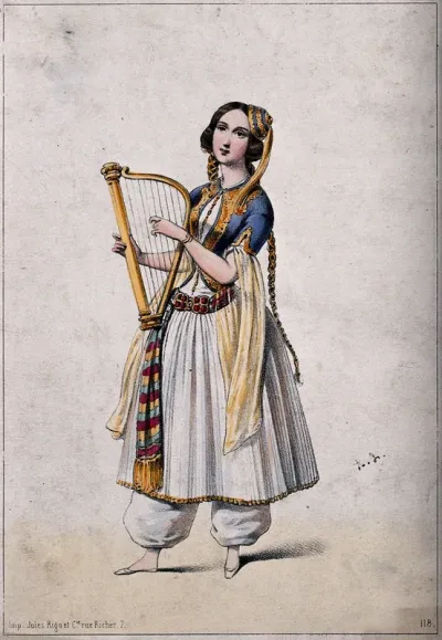 A young woman wearing a dress and pantaloons is holding a small harp
