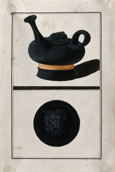 Above, black Greek lidded pouring vessel with a round body and a long spout; below, lid decorated with the head of a satyr