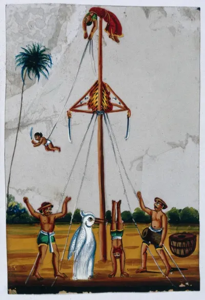 Acrobats: a woman lying on top of a pole holding on to a boy tied to one end of a rope, while someone in a penguin costume watches a man do a headstand