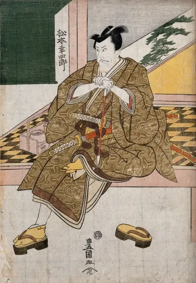 Actor Matsumoto Kōshirō V as a samurai at an open-air tea house, holding a pipe with his smoking kit at his side