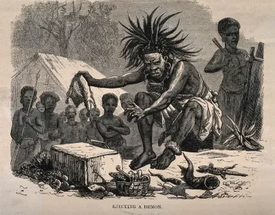 An African medicine man or shaman using symbols and small animals to eject a demon (disease)