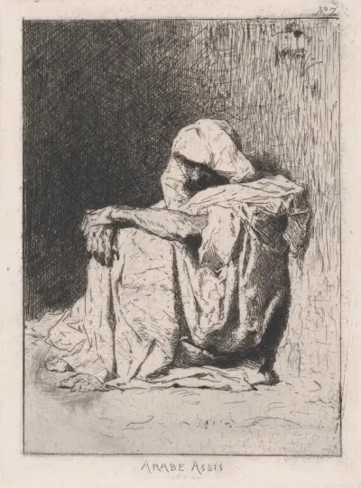 An Arabic man seated on the ground, head partly covered