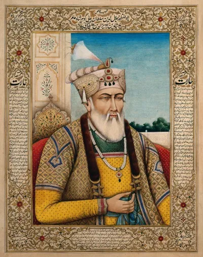 An elderly member of a royal family, holding prayer beads