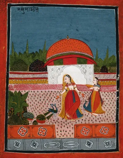 An Indian lady feeding peacocks while another woman holds a bowl
