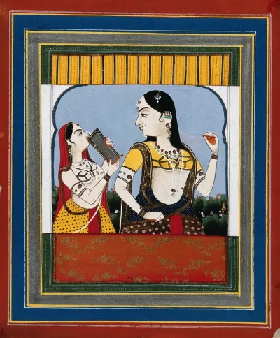 An Indian lady looking into a small mirror held by another woman