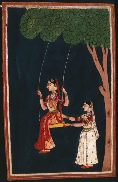 An Indian lady on a swing being pushed by another Indian woman