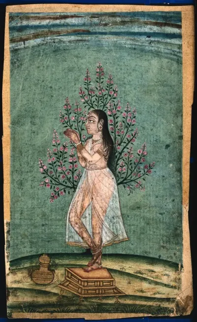 An Indian lady standing next to a tree and praying