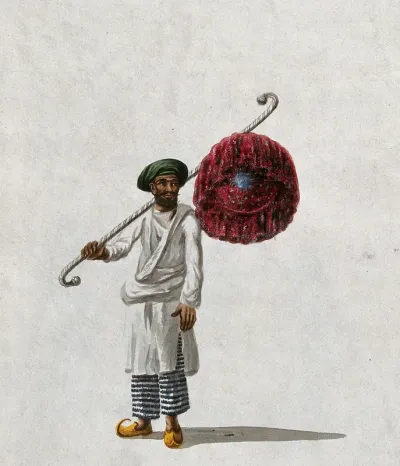 An Indian man holding a fan (?)