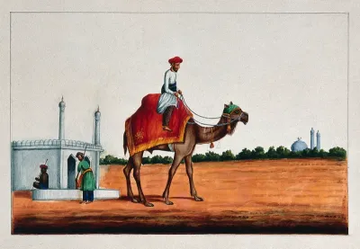An Indian man riding a camel
