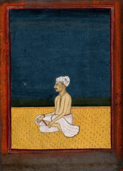 An Indian man seated
