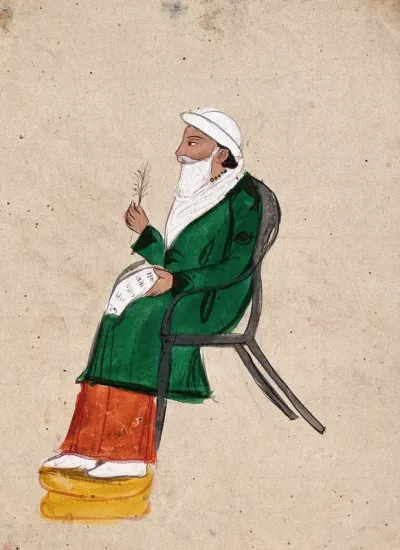 An Indian man sitting on a western chair