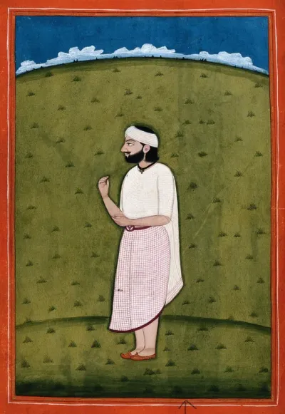 An Indian man standing in an open field