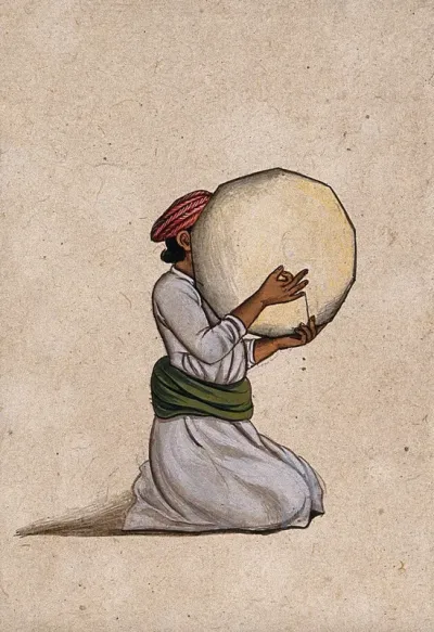 An Indian musician playing a tambourine without jingles
