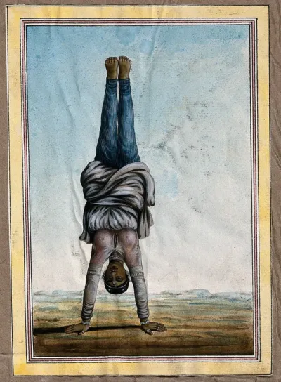 An Indian woman standing upside down on her hands