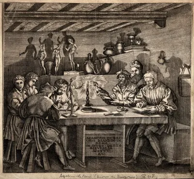 An interior in candlelight with male figures seated around a table drawing: with sculptures and vases arranged on shelf and table