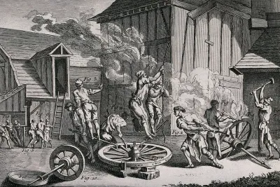 An iron forge in which metal linings are being applied to the rims of wheels