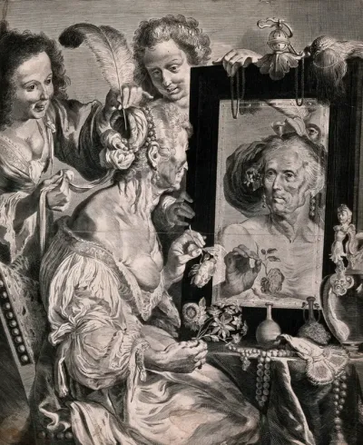 An old lady sitting at her dressing table mirror holding flowers, two younger women are putting feathers in her hair