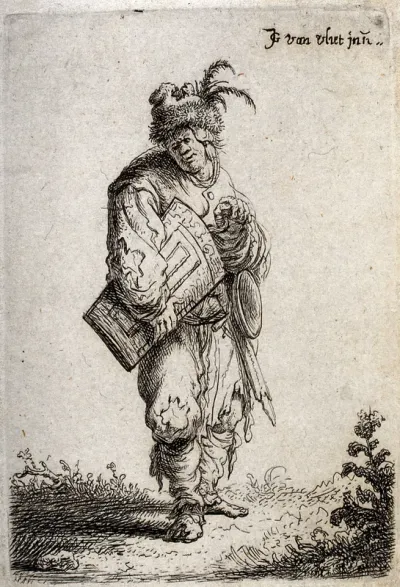 An old man in ragged clothes and a feathery fur cap playing the hurdy gurdy