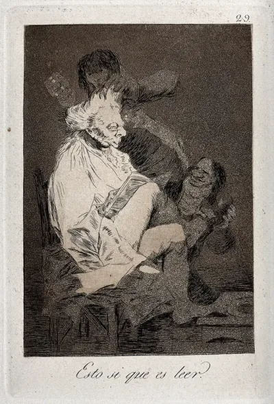 An old man is reading while his valets are attending to his toilet