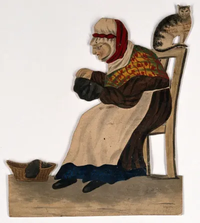 An old woman seated, sewing, with a cat on the back of her chair
