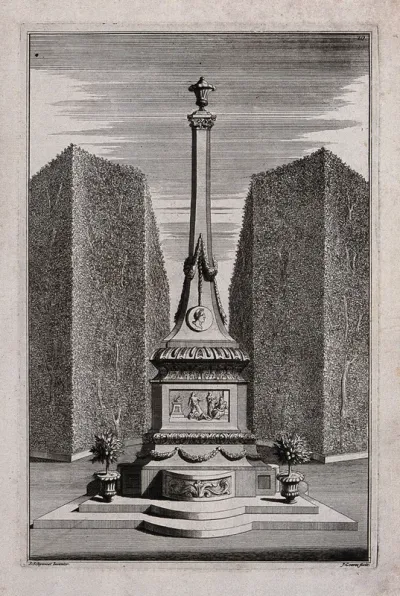 An ornate garden obelisk flanked by potted citrus trees