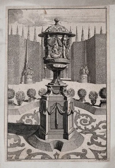 An ornate vase and pedestal with a lady and her servant carved on the side, in a classical garden