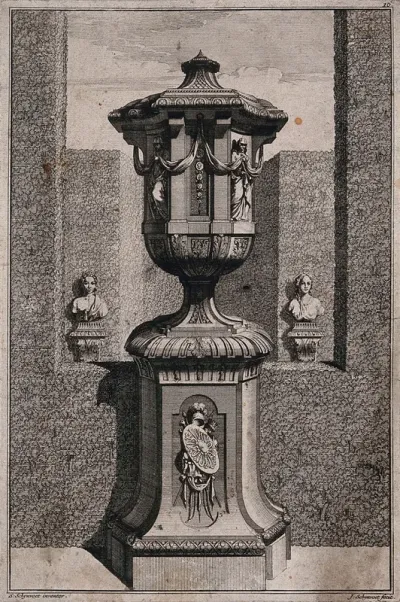 An ornate vase and pedestal with two women and a chain of medals carved on the side
