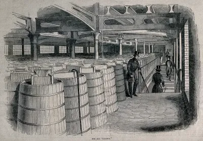Barclay and Perkins brewery, Southwark: visitors in a storeroom full of casks of ale