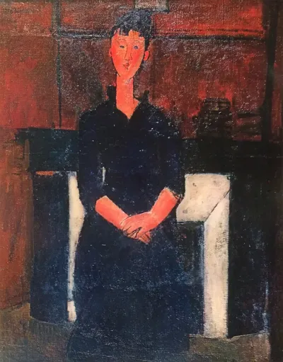Beatrice Hastings seated in front of the fireplace