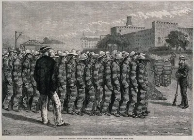 Blackwell's Island Penitentiary, New York: prisoners in uniform are marching towards the penitentiary after hard labour outside, supervised by armed guards