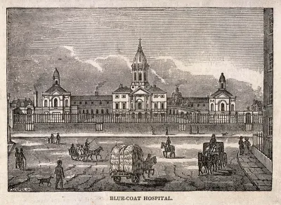 Blue-coat Hospital, London: the front elevation, with horse-drawn and pedestrian traffic in the foreground