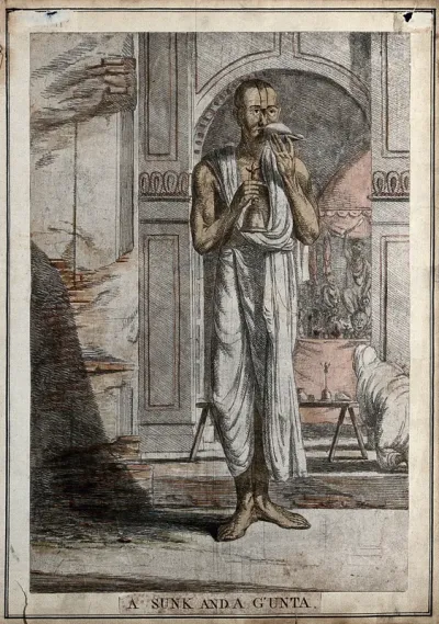 Brahman priest with a musical shell and a bell, being used at a religious ceremony, Calcutta, West Bengal