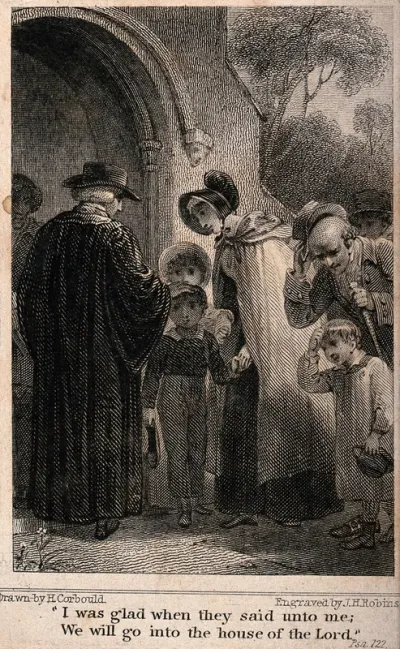 Children being blessed by the vicar at the entrance to a church