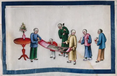 Chinese figures inspecting a painted scroll