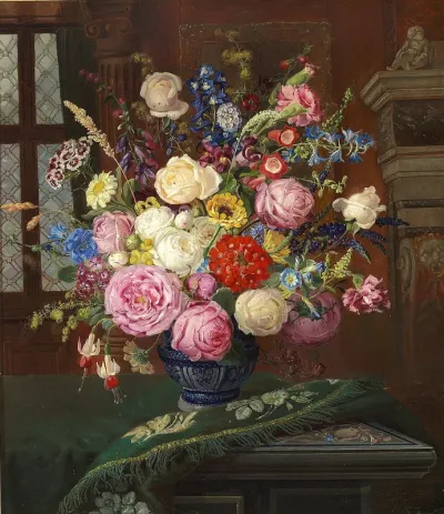 Colourful bouquet of summer flowers in a vase on a table.