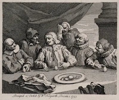 Columbus breaking the egg; he is surrounded by five men around a dinner table with a plate of eels before them