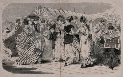 Crowds of people are out walking on Brighton pier: a woman is being pushed in a bath chair, a large lady is carrying a parasol, and three young women are being scrutinised by a variety of men