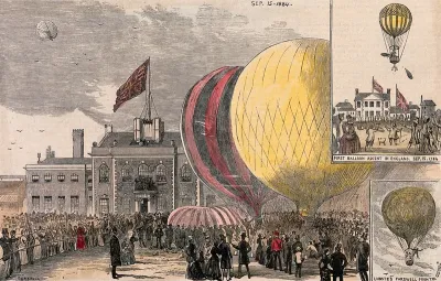 Crowds of people gathered in a square, with hot-air balloons on the ground