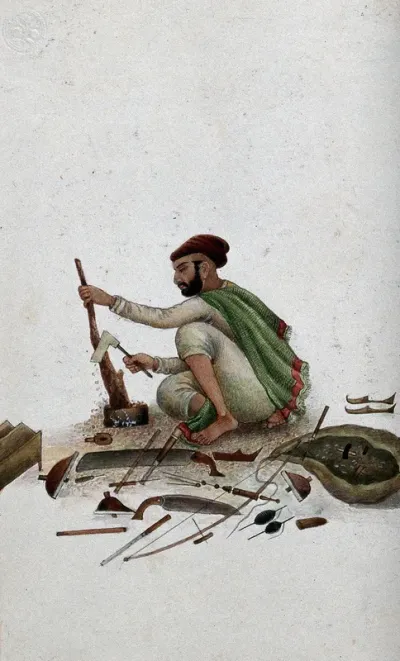 Delhi: a carpenter chipping at wood