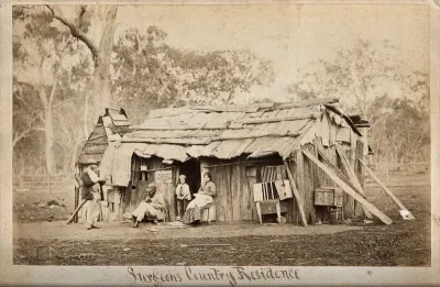 Doctor Smith, an Australian surgeon, sitting outside a shack, reading a book