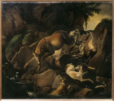 Dogs chasing a deer in a rocky riverbed