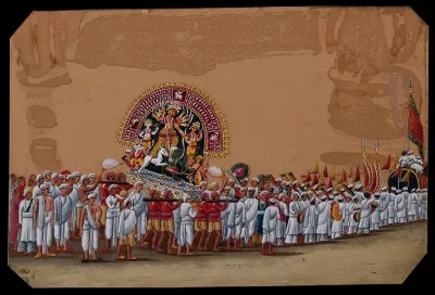 Durga Puja: a procession with people carrying the statue of goddess Durga and bright flags and pennants