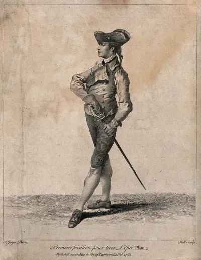 Fencing: a man is standing in position with his hand on the sword at his side