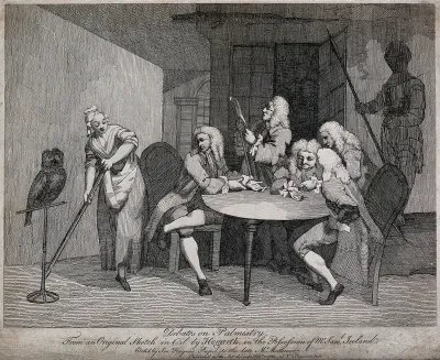 Five men congregated round a table, two of whom hold out the palm of their hands